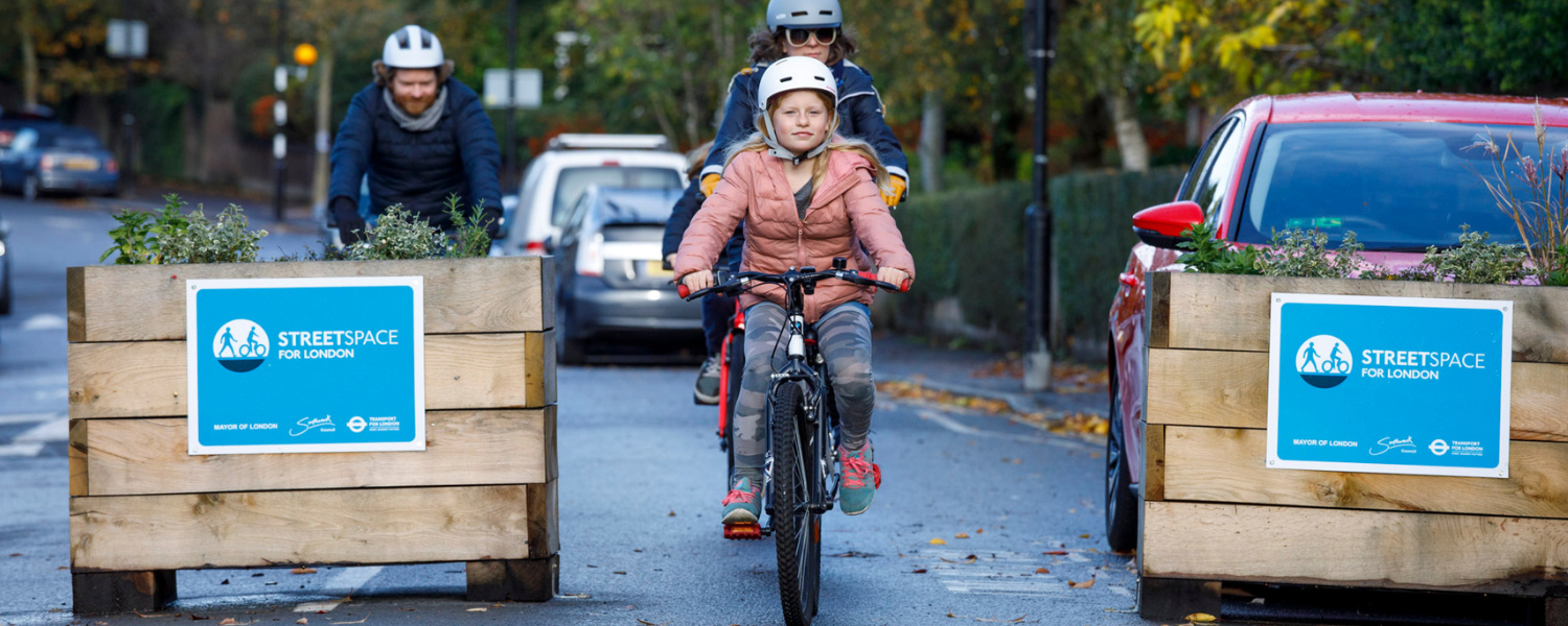 a young girl cycling along a restricted road